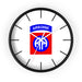 The 82nd Airborne Wall Clock, known for its high quality, features a sleek black frame and a pristine white face. At the center of the face is the insignia of the U.S. Army's 82nd Airborne Division, displaying a blue "AIRBORNE" tab above a red rectangle with a white and blue double "A" logo. Encircling the clock face are black hour marks that add an elegant touch to any personalized space.