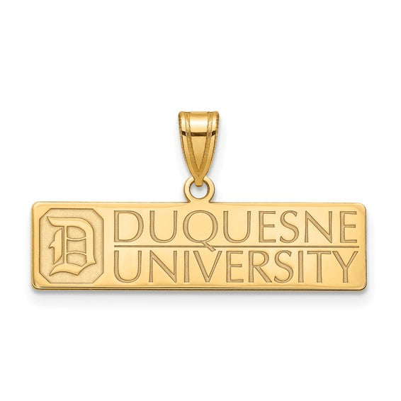 A rectangular, gold-plated SS w/GP Duquesne University Large Pendant with an inscription that reads "DUQUESNE UNIVERSITY" in uppercase letters. On the left side of the large pendant, there is a stylized, uppercase letter "D." The pendant has a polished finish and a loop at the top for attaching to a chain.