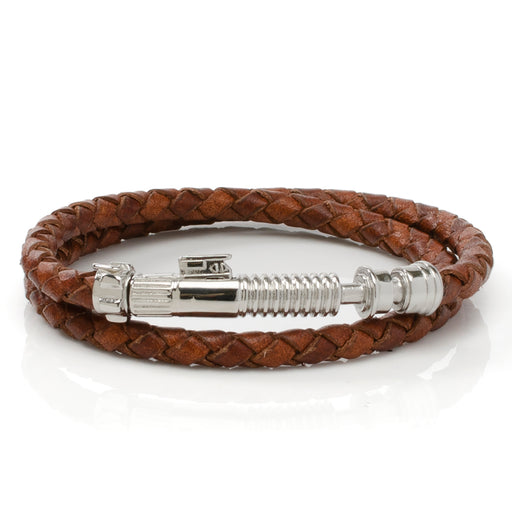 Introducing the Obi-Wan Kenobi Lightsaber Brown Bracelet: A captivating accessory featuring a braided leather band and a metallic charm reminiscent of Obi-Wan Kenobi’s lightsaber hilt. Illustrated coiled in a circular shape against a white background, this bracelet embodies the adventurous essence inspired by Lucasfilm LTD's legendary Star Wars saga.