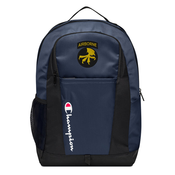 The 17th Airborne Division Champion Backpack in dark blue and black showcases a "Champion" logo, a mesh side pocket, a top handle and a 17th Airborne Division logo on the front. Crafted from water-resistant material, this sports backpack is ideal for all-weather use.