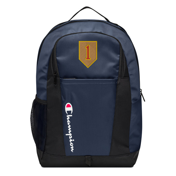 The 1st Infantry Division Champion Backpack in dark blue and black showcases a "Champion" logo, a mesh side pocket, a top handle and a 1st Infantry Division logo on the front. Crafted from water-resistant material, this sports backpack is ideal for all-weather use.