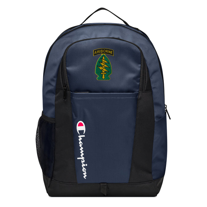 The Special Forces Airborne Champion Backpack in dark blue and black showcases a "Champion" logo, a mesh side pocket, a top handle and a Special Forces Airborne logo on the front. Crafted from water-resistant material, this sports backpack is ideal for all-weather use.