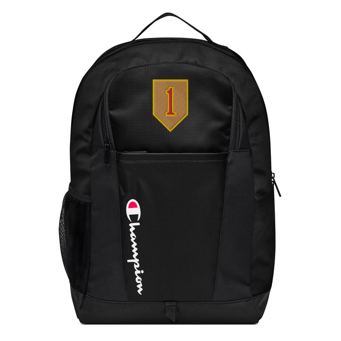 The 1st Infantry Division Champion Backpack in black showcases a "Champion" logo, a mesh side pocket, a top handle and a 1st Infantry Division logo on the front. Crafted from water-resistant material, this sports backpack is ideal for all-weather use.