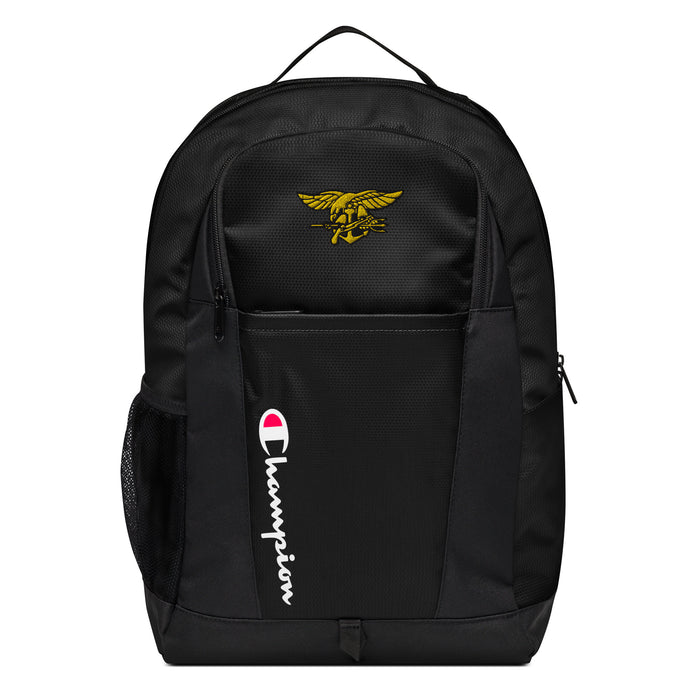 The Navy Seals Champion Backpack in black showcases a "Champion" logo, a mesh side pocket, a top handle and a Navy Seals logo on the front. Crafted from water-resistant material, this sports backpack is ideal for all-weather use.