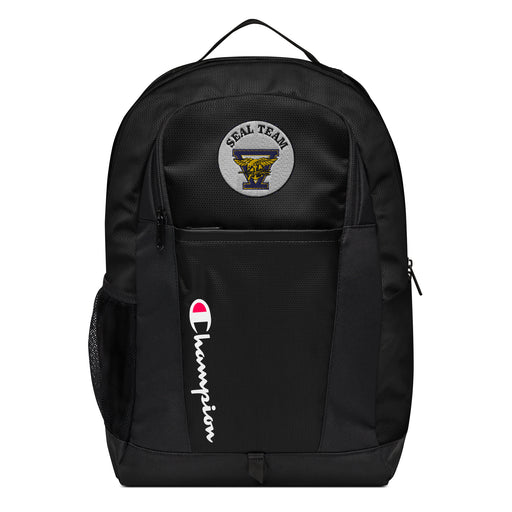 The Navy Seal Team 5 Champion Backpack in black showcases a "Champion" logo, a mesh side pocket, a top handle and a Navy Seal Team 5 logo on the front. Crafted from water-resistant material, this sports backpack is ideal for all-weather use.