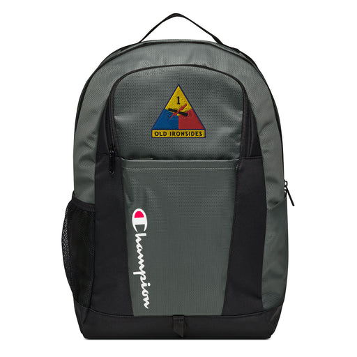 The 1st Armored Division Champion Backpack in gray and black showcases a "Champion" logo, a mesh side pocket, a top handle and a 1st Armored Division logo on the front. Crafted from water-resistant material, this sports backpack is ideal for all-weather use.