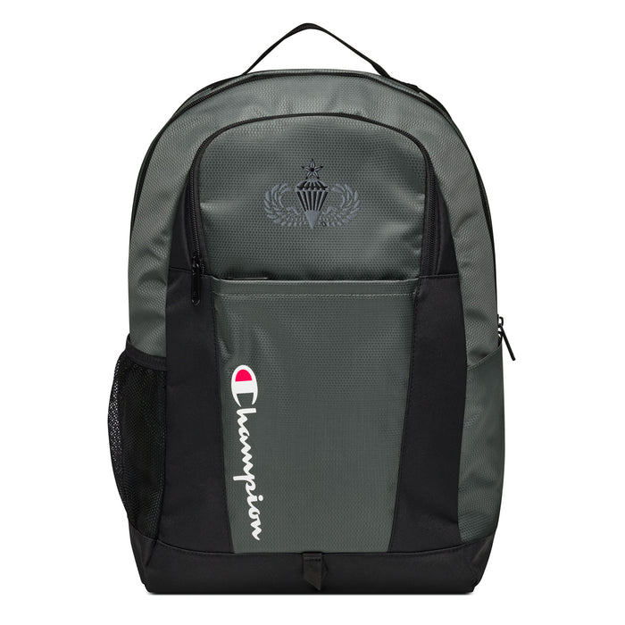 The Senior Parachutist Champion Backpack in gray and black showcases a "Champion" logo, a mesh side pocket, a top handle and a Senior Parachutist logo on the front. Crafted from water-resistant material, this sports backpack is ideal for all-weather use.