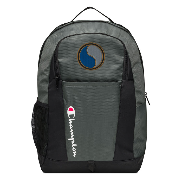 The 29th Infantry Division Champion Backpack in gray and black showcases a "Champion" logo, a mesh side pocket, a top handle and a 29th Infantry Division logo on the front. Crafted from water-resistant material, this sports backpack is ideal for all-weather use.