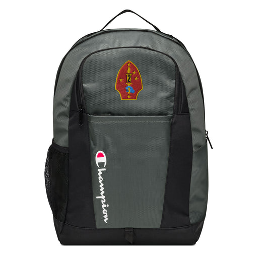 The 2nd Marine Division Champion Backpack in gray and black showcases a "Champion" logo, a mesh side pocket, a top handle and a 2nd Marine Division logo on the front. Crafted from water-resistant material, this sports backpack is ideal for all-weather use.