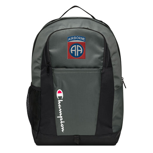 The 82nd Airborne Champion Backpack in gray and black showcases a "Champion" logo, a mesh side pocket, a top handle and a 82nd Airborne logo on the front. Crafted from water-resistant material, this sports backpack is ideal for all-weather use.