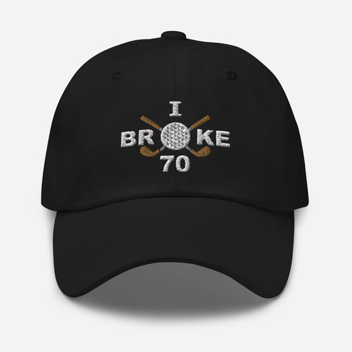 The "I Broke 70" Men's Embroidered Hat is a black, low-profile hat featuring the phrase "I Broke 70" on the front. The word "Broke" is uniquely stylized with a golf ball as the 'O' and crossed golf clubs beneath it.