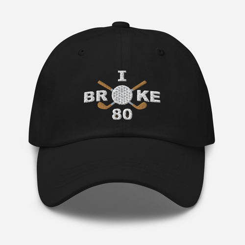 The "I Broke 80" Men's Embroidered Hat is a black, low-profile hat featuring the phrase "I Broke 70" on the front. The word "Broke" is uniquely stylized with a golf ball as the 'O' and crossed golf clubs beneath it.