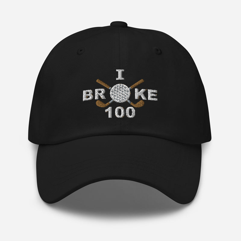 The "I Broke 100" Men's Embroidered Hat is a black, low-profile hat featuring the phrase "I Broke 70" on the front. The word "Broke" is uniquely stylized with a golf ball as the 'O' and crossed golf clubs beneath it.