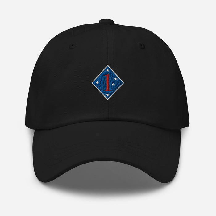 The 1st Marine Division Hat features a black design with a blue diamond-shaped patch on the front, highlighting a red "1" and four white stars in each corner. An adjustable strap ensures a comfortable fit, and it is prominently displayed against a clean white background.