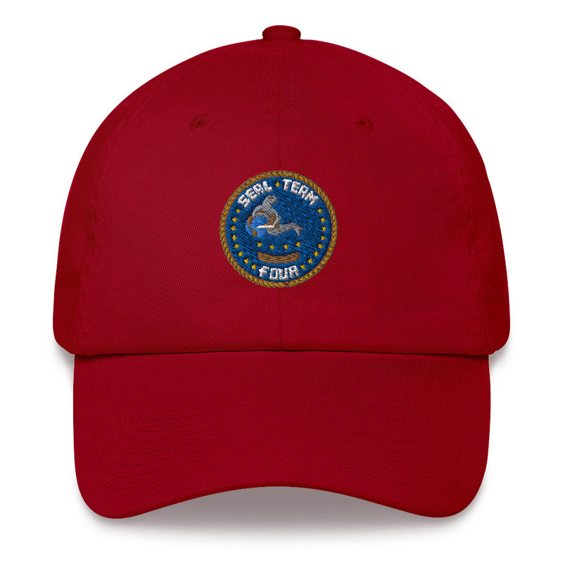 A cranberry colored Seal Team 4 Hat with the logo on the front.  The hat has a curved visor and an adjustable strap at the back.