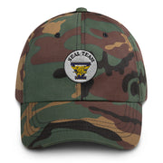 A military style Seal Team 5 Hat with camouflage and the logo on the front.  The hat has a curved visor and an adjustable strap at the back. 