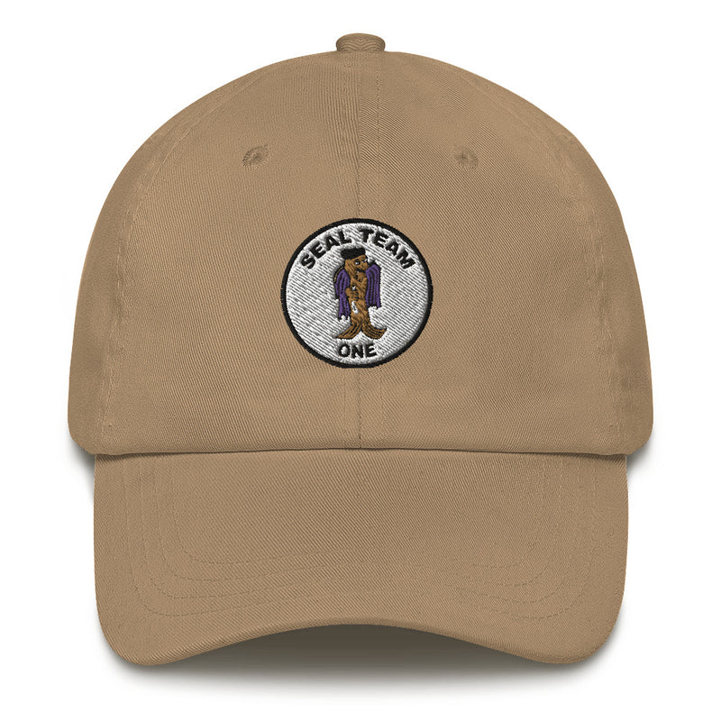 A khaki colored Seal Team 1 Hat with the logo on the front.  The hat has a curved visor and an adjustable strap at the back.