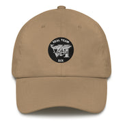 A khaki colored Seal Team 6 Hat with the logo on the front.  The hat has a curved visor and an adjustable strap at the back.