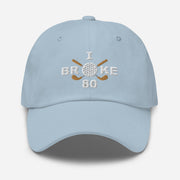 The "I Broke 80" Men's Embroidered Hat is a light blue, low-profile hat featuring the phrase "I Broke 70" on the front. The word "Broke" is uniquely stylized with a golf ball as the 'O' and crossed golf clubs beneath it.