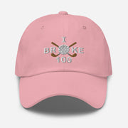 The "I Broke 100" Men's Embroidered Hat is a pink, low-profile hat featuring the phrase "I Broke 70" on the front. The word "Broke" is uniquely stylized with a golf ball as the 'O' and crossed golf clubs beneath it.