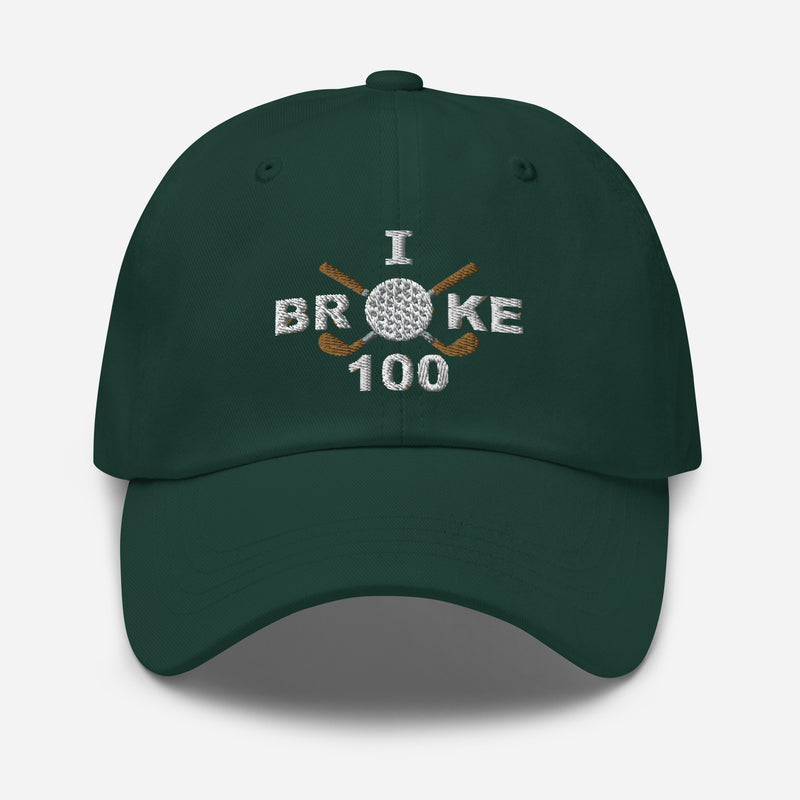 The "I Broke 10" Men's Embroidered Hat is a spruce colored, low-profile hat featuring the phrase "I Broke 70" on the front. The word "Broke" is uniquely stylized with a golf ball as the 'O' and crossed golf clubs beneath it.