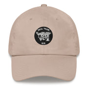 A stone colored Seal Team 6 Hat with the logo on the front.  The hat has a curved visor and an adjustable strap at the back.
