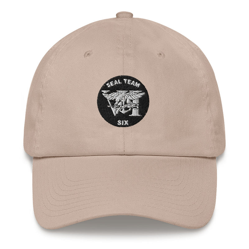 A stone colored Seal Team 6 Hat with the logo on the front.  The hat has a curved visor and an adjustable strap at the back.
