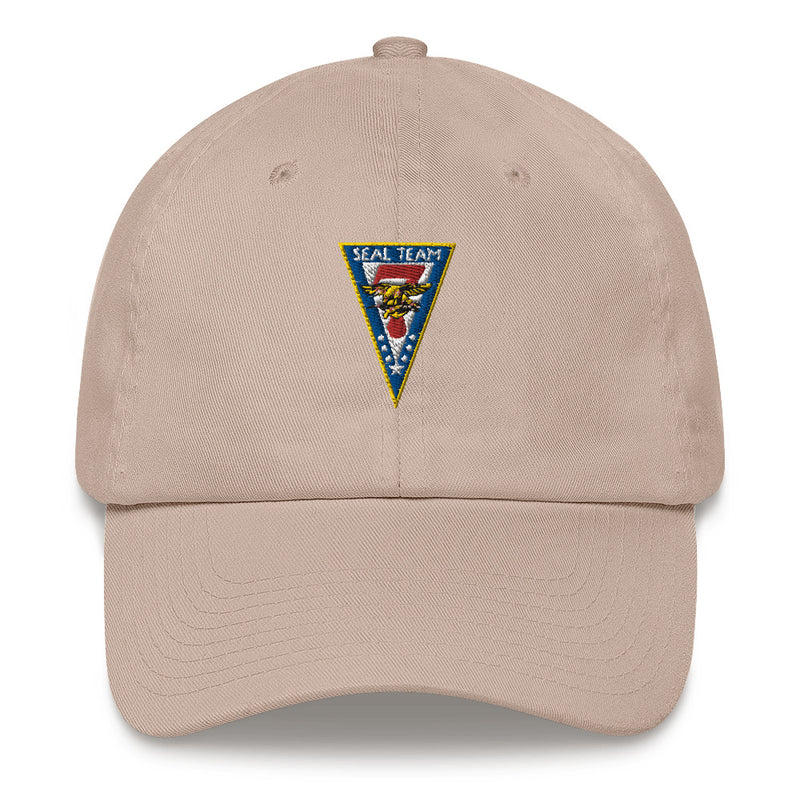 A stone colored Seal Team 7 Hat with the logo on the front.  The hat has a curved visor and an adjustable strap at the back.