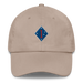 A stone colored 1st Marine Division Hat with the logo on the front.  The hat has a curved visor and an adjustable strap at the back.
