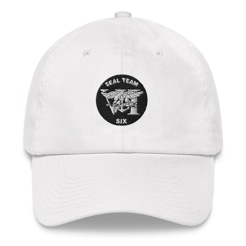 A white Seal Team 6 Hat with the logo on the front.  The hat has a curved visor and an adjustable strap at the back.