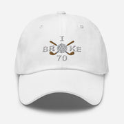 The "I Broke 70" Men's Embroidered Hat is a white, low-profile hat featuring the phrase "I Broke 70" on the front. The word "Broke" is uniquely stylized with a golf ball as the 'O' and crossed golf clubs beneath it.