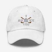 The "I Broke 100" Men's Embroidered Hat is a white, low-profile hat featuring the phrase "I Broke 70" on the front. The word "Broke" is uniquely stylized with a golf ball as the 'O' and crossed golf clubs beneath it.