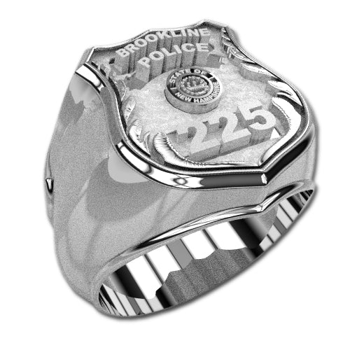 Introducing the "Police Ring - M216 Style," a sterling silver ring featuring an engraved shield design. The top is adorned with "Brookline Police," showcasing "225" and a New Hampshire emblem in the center. This department badge ring shines with a polished finish.