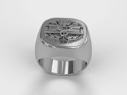 A video illustrating a sleek silver men's military style signet ring with a raised Combat Medical Badge logo rotating on a 360 degree turn table.