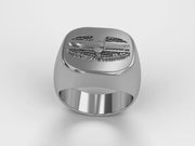 A video illustrating a sleek silver men's military style signet ring with a raised Combat Action Badge logo rotating on a 360 degree turn table.