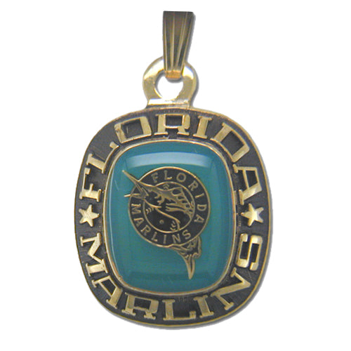 The Florida Marlins Goldtone Pendant with Enamel by Balfour Sports features the team's logo in the center against a teal background, encircled by the inscription "Florida Marlins" and flanked by two stars. Designed for Major League Baseball fans, it includes a loop at the top for attaching to a chain.