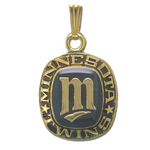 The Minnesota Twins Goldtone Pendant with Enamel prominently features the team's stylized "M" logo, complete with a curve beneath it, etched in the center and encircled by the engraved words "MINNESOTA TWINS" within a rounded rectangle shape. Designed by Balfour Sports, this pendant comes with a loop at the top for easy attachment to a chain.