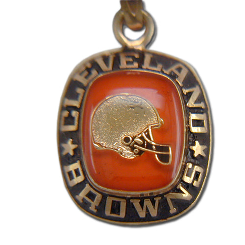 The Cleveland Browns Goldtone Pendant with Enamel features an orange center with a football helmet and bold "CLEVELAND BROWNS" lettering encircling the edge, separated by stars—a distinctive sports accessory.