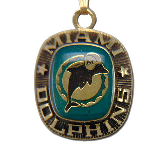 The Miami Dolphins Goldtone Pendant with Enamel features the team’s dolphin logo at the center, “MIAMI DOLPHINS” text with stars, all set against a vivid teal enamel background.