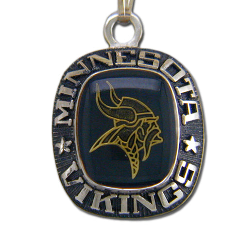 The Minnesota Vikings Celestrium Pendant with Enamel features a gold Viking head on a dark background, surrounded by “MINNESOTA VIKINGS” in raised silver—an essential team necklace for devoted NFL jewelry fans.