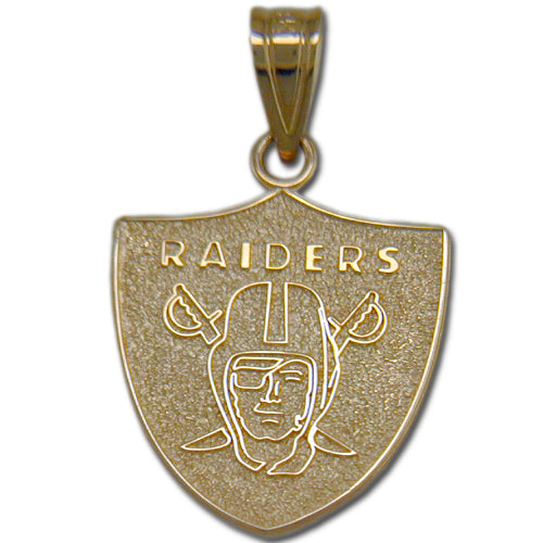 This Oakland Raiders Shield Medium Pendant, crafted by Michael Anthony Jewelry, is made of 14 Kt gold and shaped like a shield. It features the iconic Oakland Raiders logo with detailed etchings of a pirate with an eye patch wearing a football helmet and crossed swords behind his head, along with "RAIDERS" engraved above.