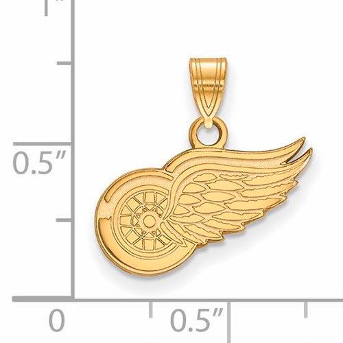 The SS w/GP NHL Detroit Red Wings Small Pendant is a Gold-Plated Sterling Silver pendant designed to resemble a wheel with a feathered wing. It features a loop at the top for easy attachment to a necklace, and based on the ruler scale in the background, the pendant measures approximately 0.5 inches in width and 0.75 inches in height.