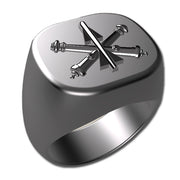 A sleek silver men's military style signet ring with a raised Air Defense Artillery logo on top and boasting a modern, polished finish.