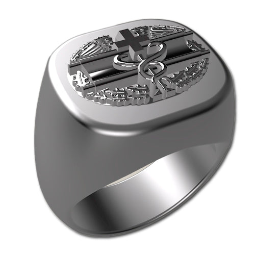 A sleek silver men's military style signet ring with a raised Combat Medical Badge logo on top and boasting a modern, polished finish.
