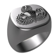 A sleek silver men's military style signet ring with a raised Master Parachutist Badge logo on top and boasting a modern, polished finish.
