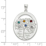 An Oval Silver Pendant With 6 Birthstones, featuring a detailed tree design with four colorful gems. Each branch holds a birthstone and a name. The pendant is shown on a ruled background.