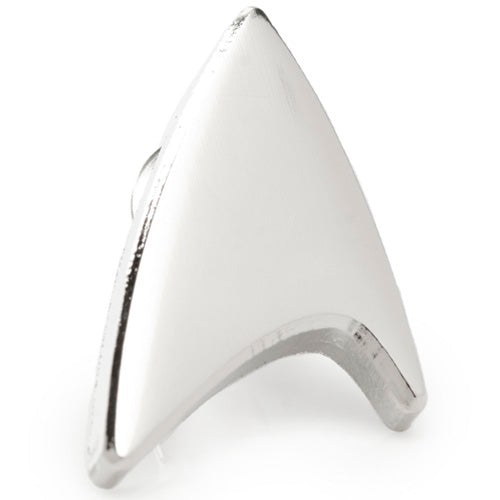 The Silver Delta Shield Lapel Pin is a metallic, triangular badge featuring a curved bottom edge and a smooth, polished silver material surface. Resembling the iconic Starfleet insignia from Star Trek, it is officially licensed by CBS Studios Inc.