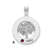 The Circle Pendant With 1 Birthstone showcases a round silver pendant featuring a detailed tree cutout. A small red birthstone is set at the bottom left of the tree, with the name "Ashley" inscribed nearby. This high-quality gold pendant hangs from a decorated bail, which has the letter "A" on its left side.