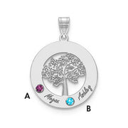 The Circle Pendant With 2 Birthstones is a quality silver accessory featuring a detailed tree in the center. It includes two colored gems: one purple (A) and one blue (B). "Megan" is engraved next to gem A, while "Ashley" is engraved next to gem B. This birthstone pendant has a loop at the top for attaching to a necklace chain.