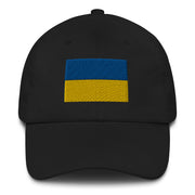A black Ukrainian Flag Hat with the logo on the front.  The hat has a curved visor and an adjustable strap at the back.